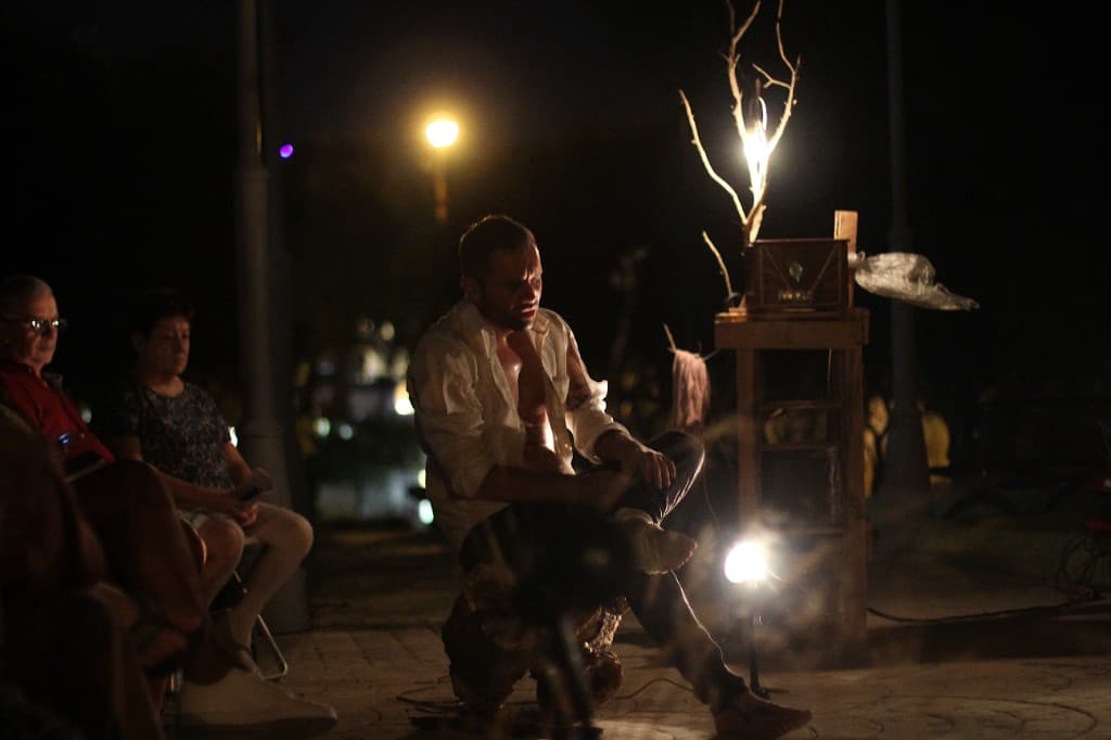 Actor performing at night under a warm spotlight